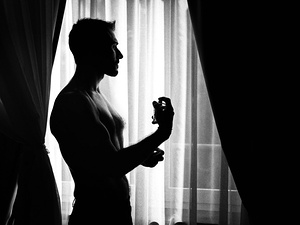 alt=Groom getting ready in elegant attire for a destination wedding in Italy