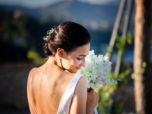 alt=Romantic portrait of the bride with flowers at sunset at Brown Castle, Portofino, destination wedding italy