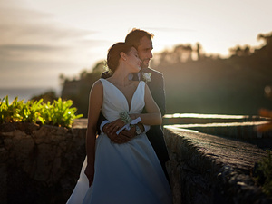 alt=Romantic couple portrait at sunset at Castello Brown, Portofino,destination wedding