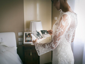 alt=The bride reads a congratulatory message