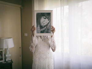 alt=intimate moments of the bride with the wedding dress before the wedding