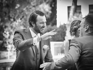 alt=The groom waits outside the wedding church in Sirmione