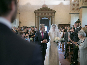 alt=bride's entrance into the church for the wedding ceremony