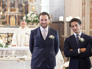 alt=The groom waits at the altar in the church on Lake Garda