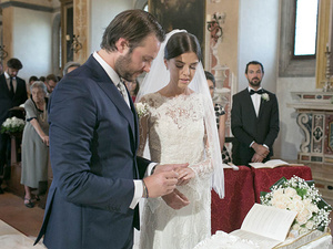 alt=moment of exchanging rings at the religious wedding ceremony