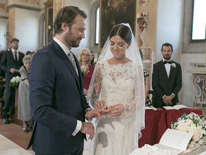 alt=moment of exchanging rings at the religious wedding ceremony