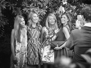 alt=Bridesmaids during the reception pose for a photo shoot with a professional photographer