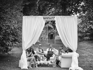 alt=guests seated under a white gazebo at Giorgia and Davide's wedding