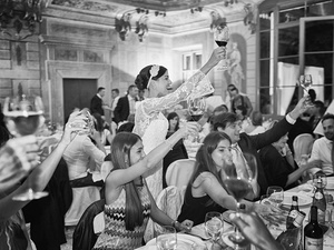 alt=The bride toasts with friends during the reception at Villa Mosconi Bertani, Lake Garda