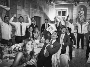 alt=friends of the bride and groom toast at the wedding reception